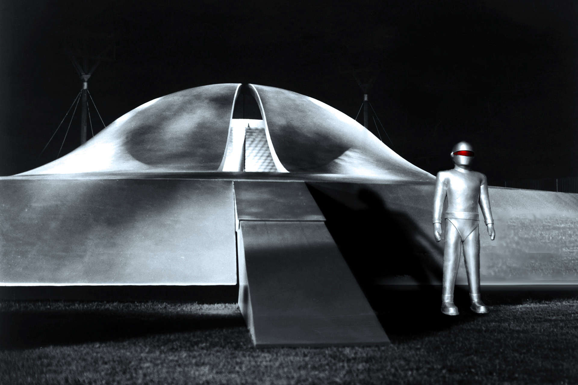 Futuristic astronaut figure standing beside a sleek, modern spacecraft at night, emphasizing innovative aerospace design and space exploration themes.
