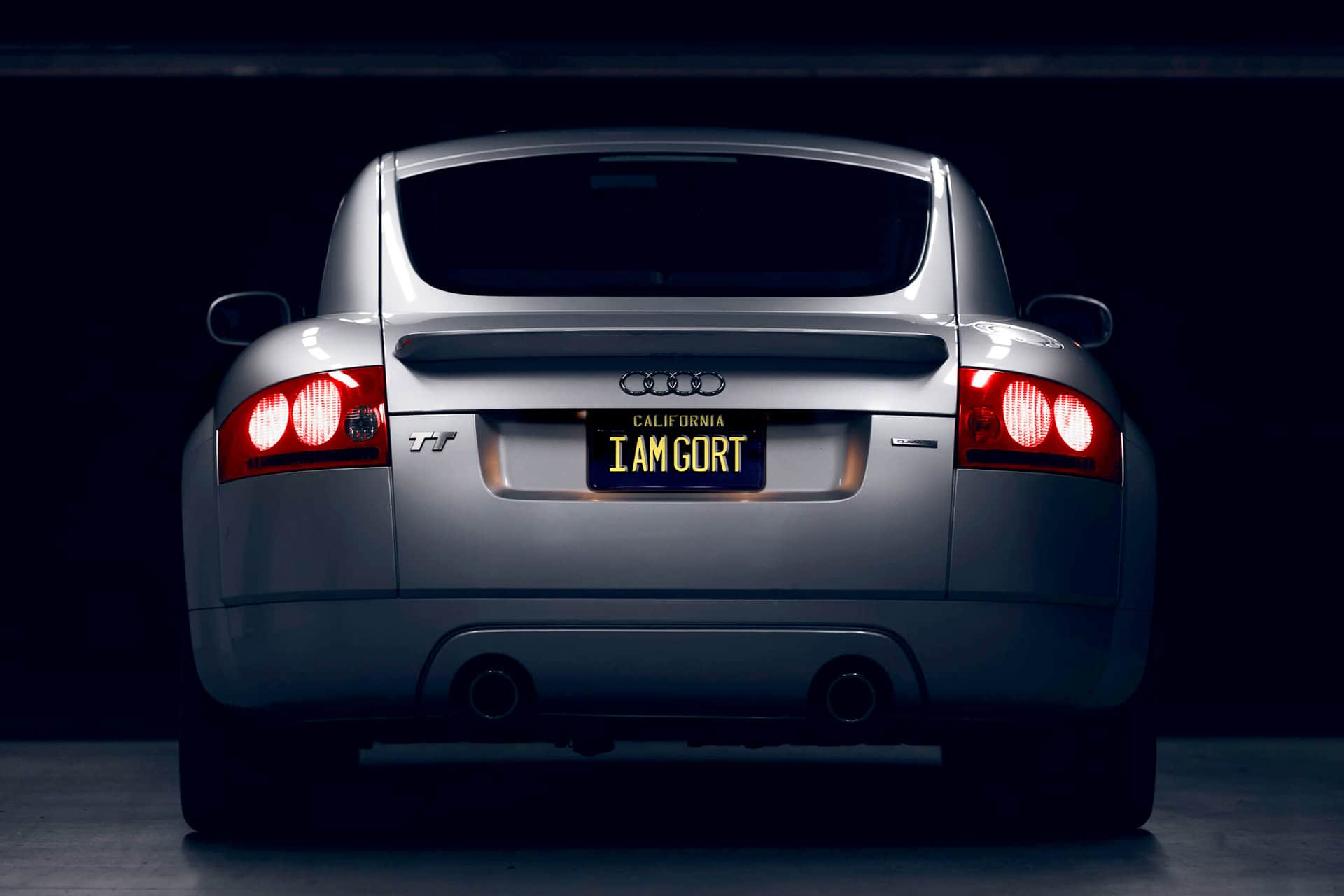 TT-Rear Luxury silver Audi TT with custom California license plate "I AM GORT" showcasing sleek design and sporty appeal from iamgort.com.